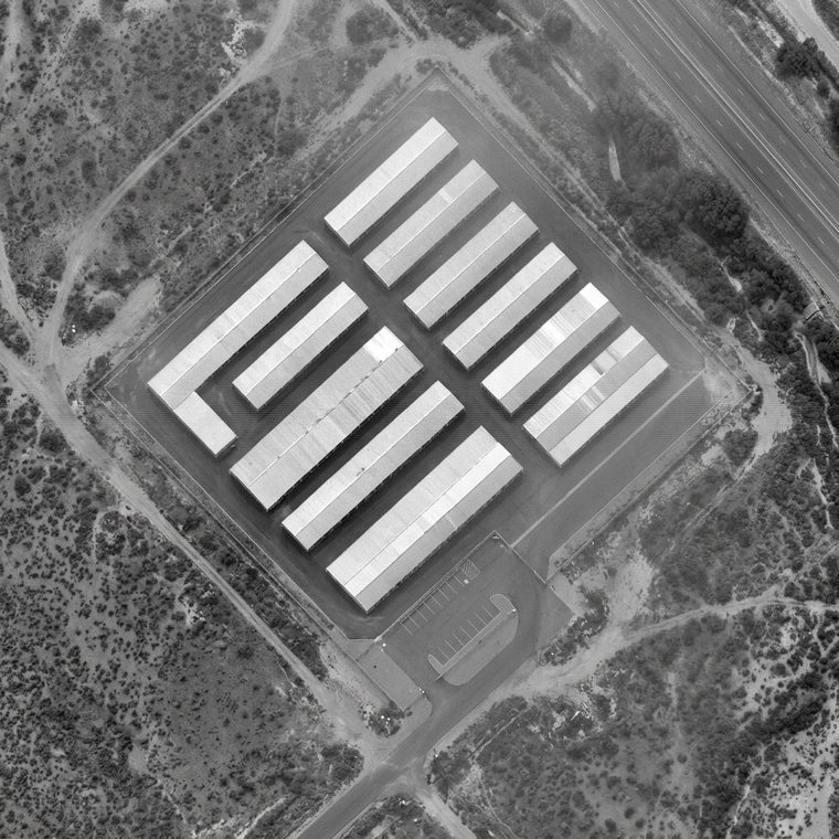 Monochrome overhead surveillance frame of a self-storage facility and its perimeter